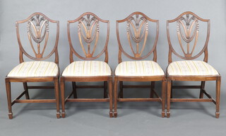 A set of 4 Georgian style shield back dining chairs with Prince of Wales feather decoration, upholstered drop in seats, raised on square tapered supports with H framed stretcher 97cm h x 50cm w x 42cm d
