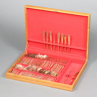 A canteen of Thai gilt bronzed flatware contained in a teak canteen box 
