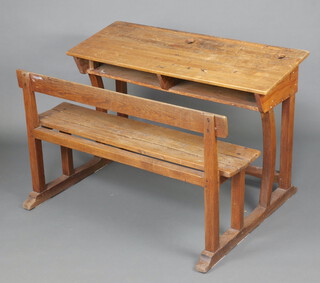A 19th/20th Century elm school double desk incorporating a seat 73cm h x 110cm w x 74cm d (no inkwells) 