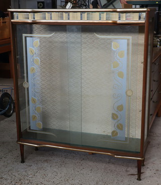 A 1950's laminate and glazed display cabinet fitted shelves enclosed by glazed panelled doors 109cm h x 90cm w x 30cm d 