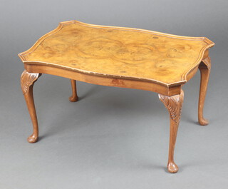 A Queen Anne style quarter veneered figured walnut coffee table of serpentine outline, raised on cabriole supports 42cm x 75cm x 50cm d 