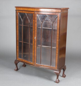 A 1930's Georgian style mahogany display cabinet of serpentine outline the interior fitted adjustable shelves enclosed by astragal glazed panelled doors, raised on cabriole ball and claw supports 121cm h x 90cm w x 35cm d 