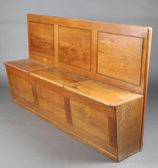 A 1930's Art Deco teak settle with panelled back, the base fitted 3 lockers with hinged lid 108cm h x 179cm w x 40cm d 