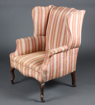 An Edwardian winged armchair upholstered in striped material, raised on cabriole supports 100cm h x 70cm w x 61cm d (seat 27cm x 28cm) 