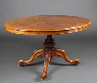 A Victorian oval quarter veneered figured walnut snap top loo table, raised on pillar and tripod base 75cm h x 135cm w x 105cm