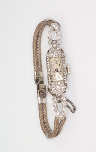 A lady's white metal plat. diamond set cocktail watch on silk strap