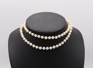 A strand of cultured pearls with a 9ct yellow gold garnet and pearl set clasp 62cm 