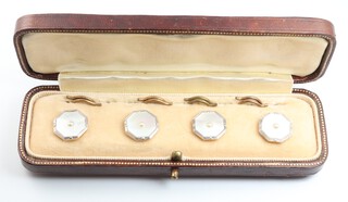 A cased set of Edwardian yellow metal 9ct and 18ct octagonal studs with mother of pearl and cultured seed pearls, cased 