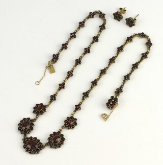 A Victorian gilt garnet set necklace and ear studs 
