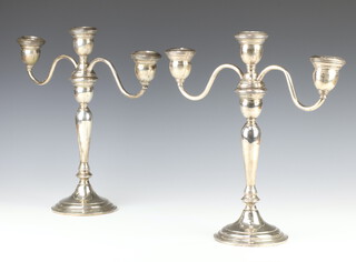 A pair of sterling silver 3 light candelabra, weighted, 30cm 