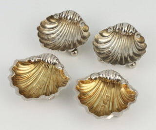 A pair of Victorian repousse silver shell shaped salts Chester 1894, a ditto pair Chester 1906, 33 grams 