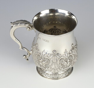 A Victorian repousse baluster silver mug decorated with flowers and vacant cartouche, London 1896, 9cm, 201 grams 