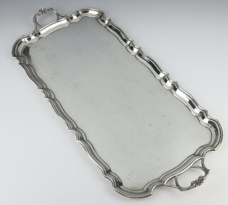 A rounded rectangular 2 handled silver tray with Chippendale rim, Sheffield 1938, 1647 grams, 60cm 