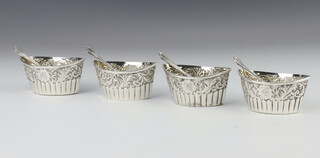 Four repousse silver Victorian boat shaped table salts Birmingham 1891, with 4 spoons, 99 grams 