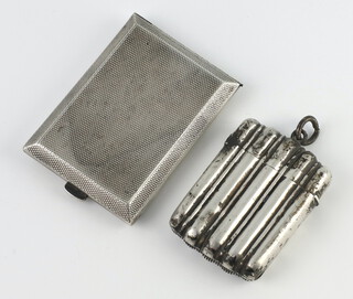 A Victorian silver vesta Birmingham 1891 with ribbed decoration and a silver match sleeve holder Birmingham 1928 
