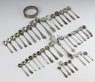 A silver bangle and minor silver condiment spoons 124 grams 