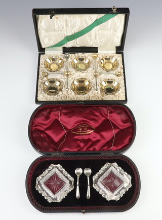 A cased set of 6 silver plated hexagonal salts and spoons together with a cased pair