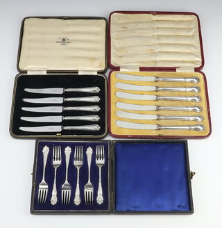 A cased set of 6 silver handled butter knives, 2 other cased sets 