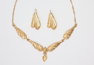 A yellow metal leaf necklace 34cm and a pair of earrings 6.3 grams 