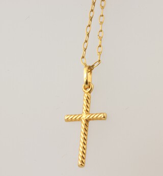 A yellow metal 9k chain 1.4 grams and an 18k yellow metal cross pendant 0.5 grams 