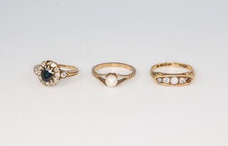 Two 9ct yellow gold gem set rings sizes K and L, 5.4 grams, an 18ct ditto 3.4 grams size N (two missing a stone)