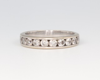 A white metal 18ct half eternity ring set with brilliant cut channel set diamonds approx. 0.7ct, size I 1/2 