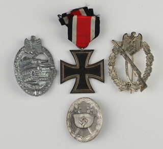 A Second World War Iron Cross dated 1939 together with a Panzer badge, a Wound badge and an Infantry assault badge