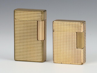 A gentleman's Dupont gilt cigarette lighter  and a lady's ditto 