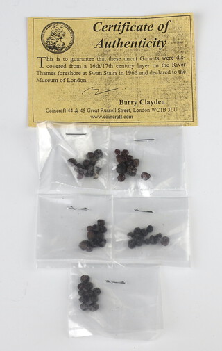 Fifty uncut garnets, recovered from the River Thames, together with Coincraft certificates of authenticity 