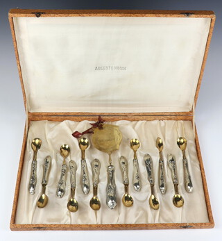 An Italian 800 standard cased set of 12 spoons and a server with gilt bowls