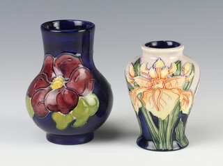 A modern Moorcroft baluster vase decorated with flowers 9cm and a blue ground ditto 10cm 