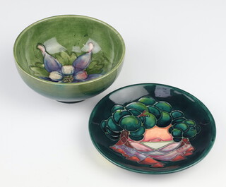 A Moorcroft pale green bowl decorated with flowers 11cm together with a modern green ground dish decorated with fruits 11cm 