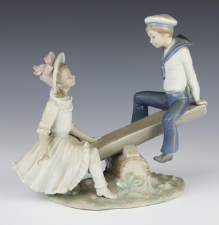 A Lladro group of a boy and girl on a see saw 22cm 