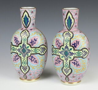 A pair of Victorian painted glass vases decorated with a cross and leaves 22cm 