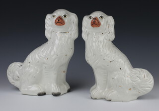 A pair of Victorian style Staffordshire spaniels with gilt decoration 30cm