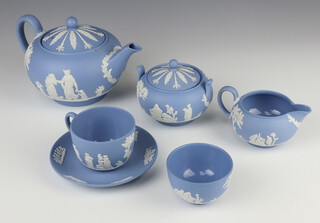 A Wedgwood blue basalt teapot and lid, sugar bowl and lid, milk jug, bowl, tea cup and saucer