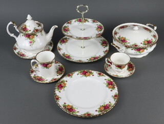 An extensive Royal Albert Old Country Roses tea, coffee and dinner service comprising 13 tea cups, 13 saucers, 12 small plates, 12 side plates, 12 dinner plates, 2 tureens and covers, 2 tier cake stand, 2 milk jugs, sugar bowl, 2 serving plates, 2 dishes, 6 coffee mugs, 6 two handled bowls, 6 saucers, 10 small plates, a sauce boat and stand, 2 teapots, cheese dish and cover, sugar bowl and cover
