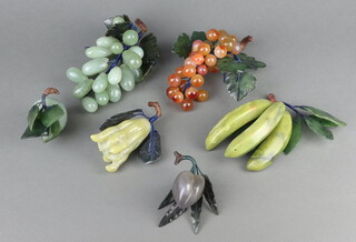 A collection of modern Chinese carved hardstone fruits comprising bananas, grapes, pomegranate, plum, apple and grapes 