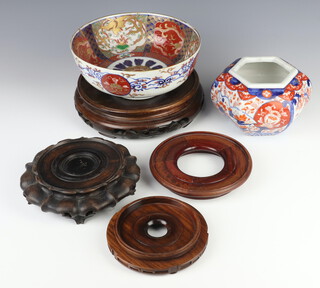 An early 20th Century Chinese Imari hexagonal bow decorated with flowers 15cm, a Japanese Imari bowl decorated with dragons and flowers 21cm and 4 hardwood stands 