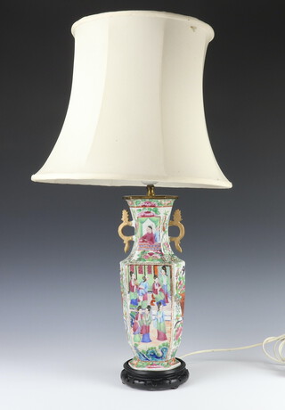 A Chinese famille rose hexagonal vase decorated with figures in pavilions and on a ground of flowers with lion handles, converted to a table lamp 33cm 