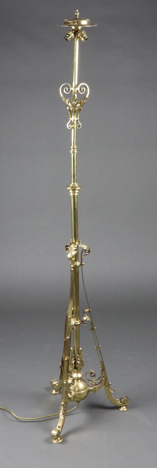 A Victorian brass adjustable oil lamp stand converted to a standard lamp with wrought decoration, 144cm x 40cm 