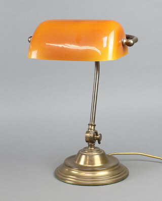 An adjustable gilt metal bank lamp with amber glass shade 36cm x 29cm  