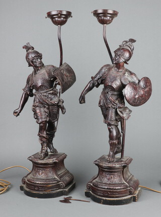 An impressive pair of Victorian spelter figures of standing warriors, raised on shaped bases, converted to table lamps, 59cm h x 22cm w x 17cm d 