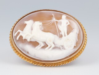 An oval yellow metal 9ct carved cameo brooch with a chariot scene 