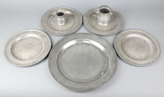 An 18th/19th Century pewter plate 33cm (some contact marks and dents), 4 pewter plates with London touch marks (some dents) 24cm, a Victorian half pint baluster shaped measure 10cm, 1 other measure (some dents)