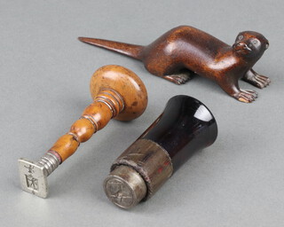 A 19th Century steel seal decorated a stork, 1 other seal with turned wooden handle 8cm and a carved wooden figure of an otter 12cm 