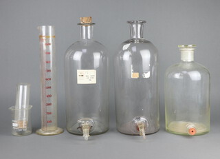 A glass laboratory measuring jug 44cm x 11cm (crack to base) and 3 large glass laboratory bottles 
