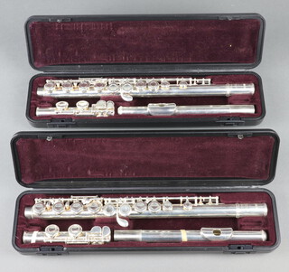 Two Yamaha 211 silver plated flutes, complete with carrying case and various music 