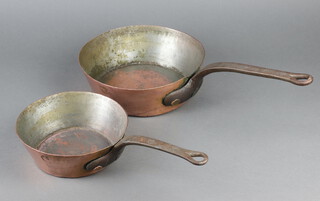 Jones Bros. of Down Street, a waisted copper pan with iron handle 8cm x 26cm and 1 other 7cm x 21cm 