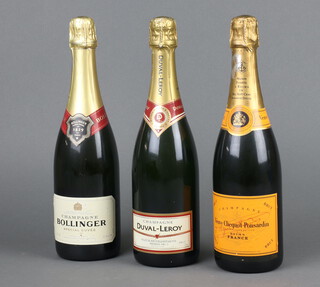 A bottle of Bollinger champagne, a bottle of Veuve Clicquot champagne and a bottle of Duval-Leroy champagne 